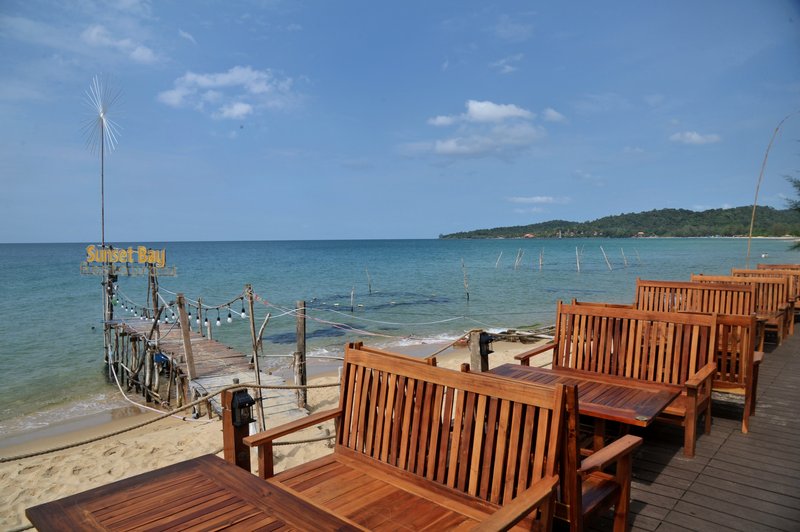 Panoramic view of pier, white sand beach, and bay
